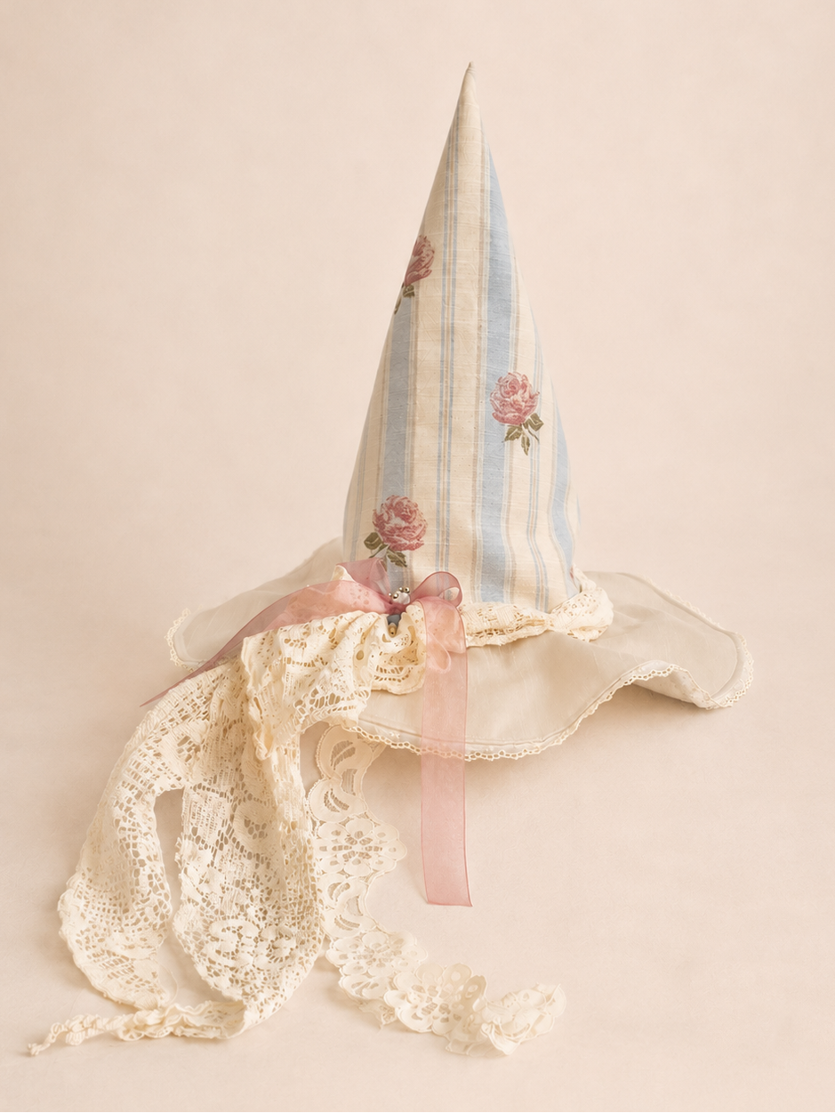 Decorative whimsy witch hat with floral design on a beige background